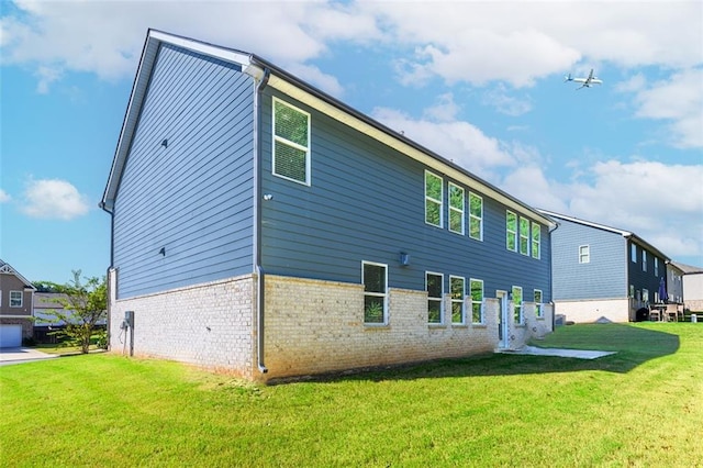 rear view of property featuring a yard