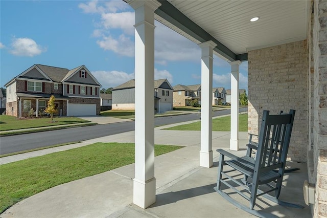 view of patio / terrace with a garage and covered porch