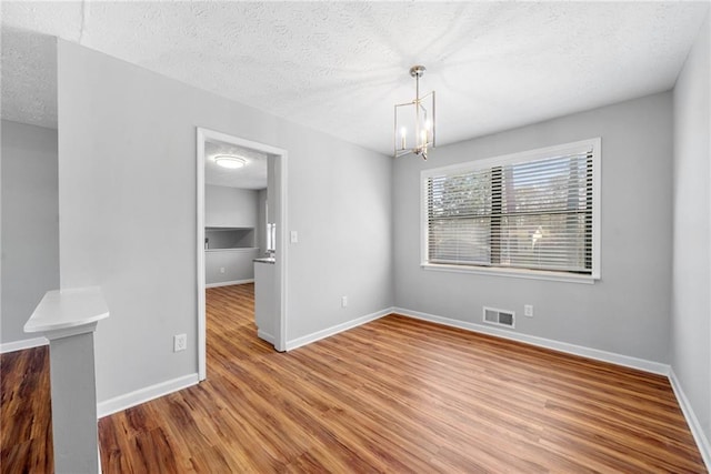 4347 Pleasant Ridge Rd, Decatur, GA 30034 - unfurnished dining area featuring a textured ceiling, wood finished floors, visible vents, and baseboards