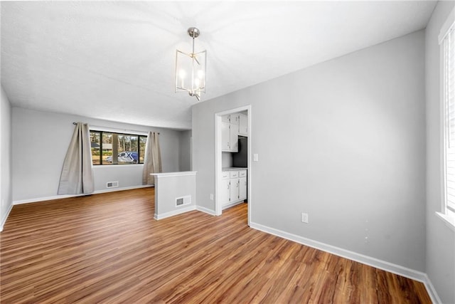 4347 Pleasant Ridge Rd, Decatur, GA 30034 - interior space featuring visible vents, light wood-style flooring, baseboards, and a notable chandelier