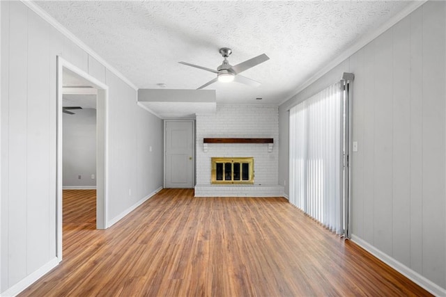 4347 Pleasant Ridge Rd, Decatur, GA 30034 - unfurnished living room with baseboards, a ceiling fan, wood finished floors, crown molding, and a fireplace