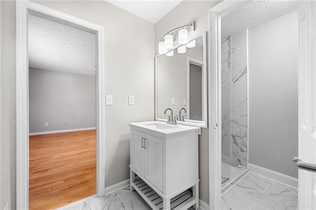4347 Pleasant Ridge Rd, Decatur, GA 30034 - bathroom with a textured ceiling, marble finish floor, a stall shower, and vanity