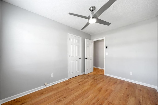 4347 Pleasant Ridge Rd, Decatur, GA 30034 - unfurnished bedroom featuring a textured ceiling, light wood finished floors, baseboards, and ceiling fan