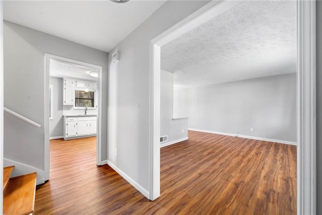 4347 Pleasant Ridge Rd, Decatur, GA 30034 - hallway with dark wood-style floors, visible vents, a sink, baseboards, and stairs