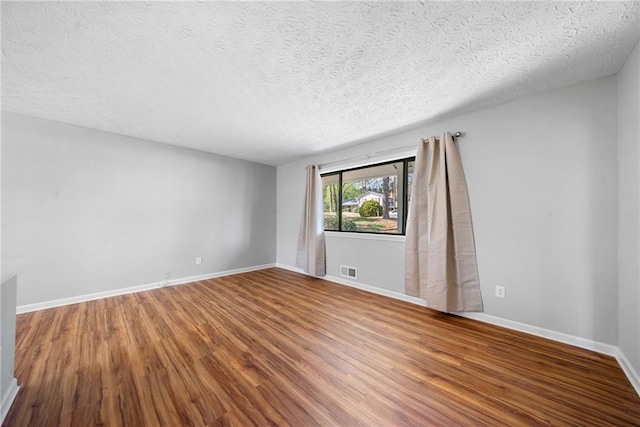 4347 Pleasant Ridge Rd, Decatur, GA 30034 - unfurnished room featuring a textured ceiling, wood finished floors, visible vents, and baseboards