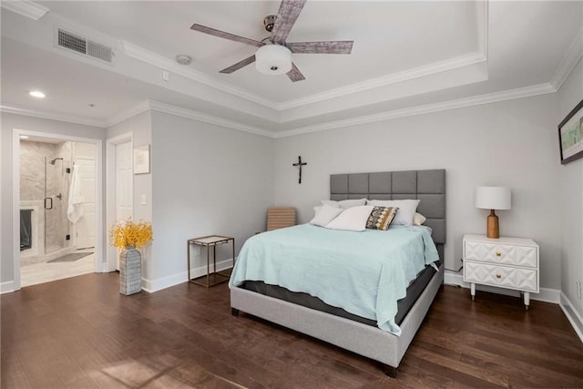 bedroom featuring ceiling fan, ensuite bath, and crown molding