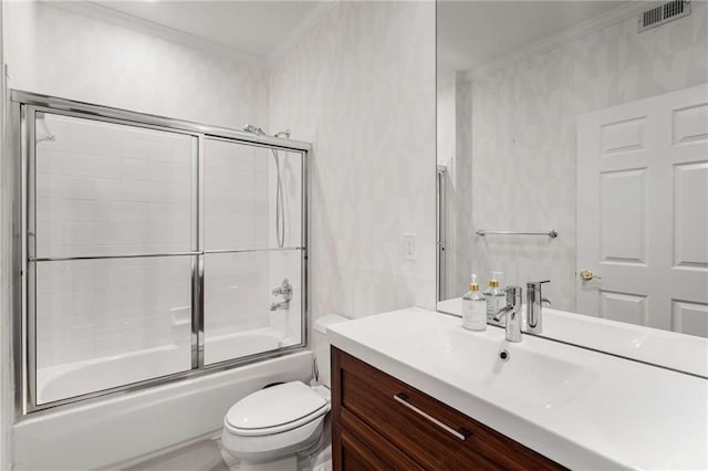 full bathroom with toilet, combined bath / shower with glass door, ornamental molding, and vanity