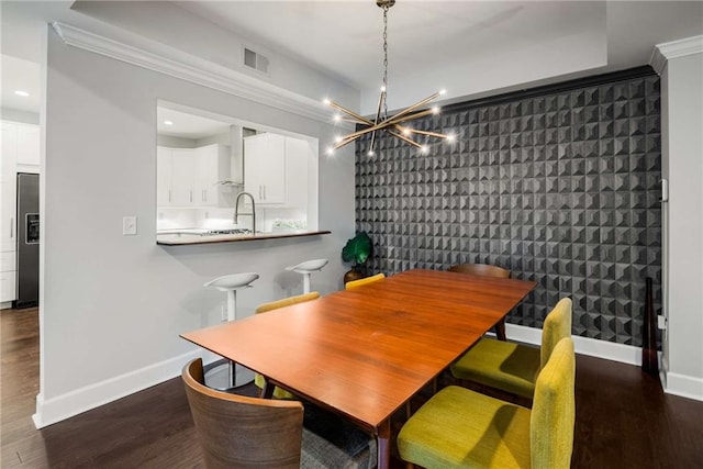 dining area featuring a notable chandelier and dark hardwood / wood-style flooring