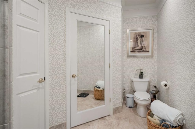 bathroom featuring toilet and crown molding