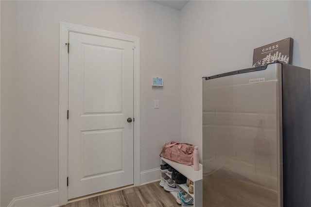 interior space featuring baseboards and wood finished floors