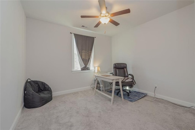 carpeted office space featuring ceiling fan, visible vents, and baseboards