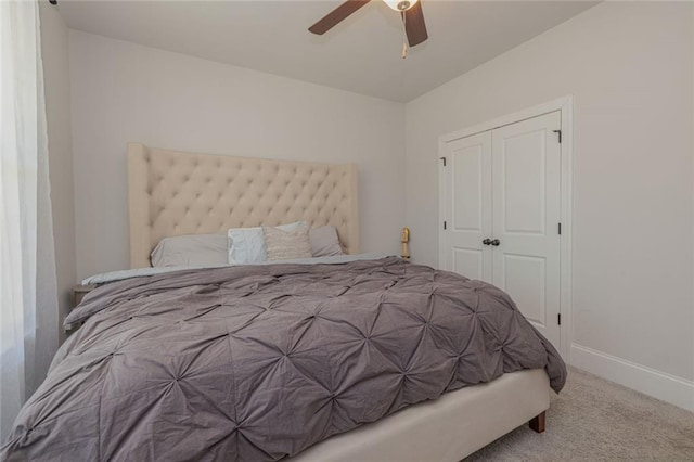 bedroom with a ceiling fan, carpet, baseboards, and a closet