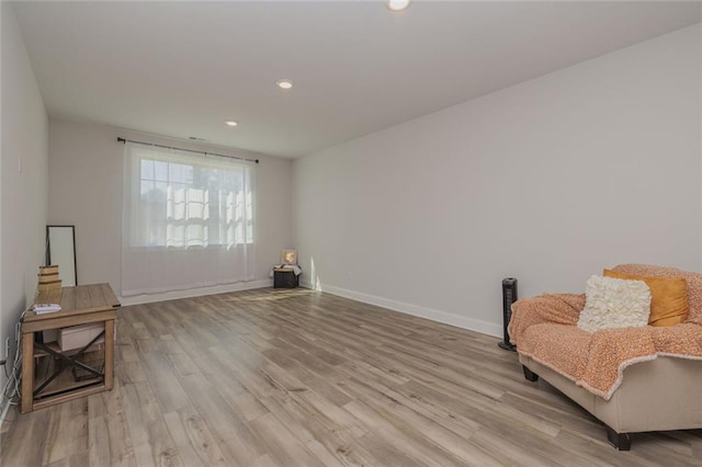 living area with light wood finished floors, recessed lighting, and baseboards