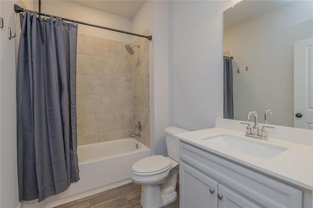 full bathroom featuring toilet, shower / bath combination with curtain, wood finished floors, and vanity