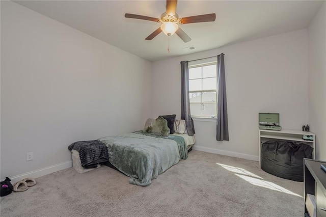 carpeted bedroom featuring visible vents, baseboards, and a ceiling fan