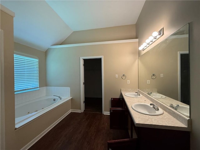 545 Platoro Ct SW, Atlanta, GA 30331 - bathroom with double vanity, wood finished floors, a jetted tub, and lofted ceiling