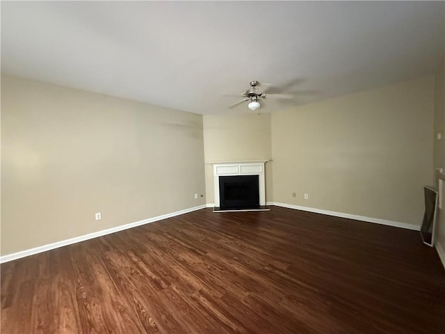 545 Platoro Ct SW, Atlanta, GA 30331 - unfurnished living room with a ceiling fan, dark wood finished floors, and a fireplace with raised hearth