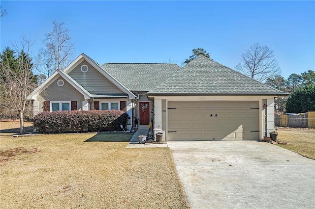 ranch-style house with a garage and a front lawn