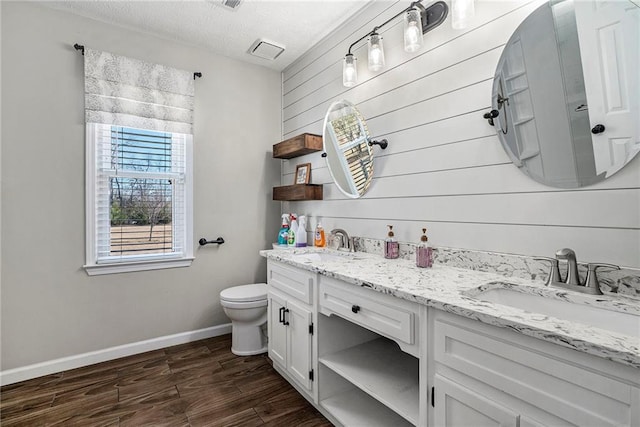 bathroom featuring vanity, toilet, and a textured ceiling