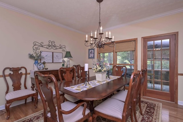 3743 Johnston Rd, Winston, GA 30187 - dining area featuring a chandelier, crown molding, wood finished floors, and a textured ceiling
