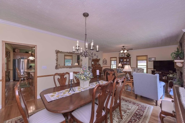 3743 Johnston Rd, Winston, GA 30187 - dining room featuring wood finished floors, a textured ceiling, a chandelier, crown molding, and ceiling fan