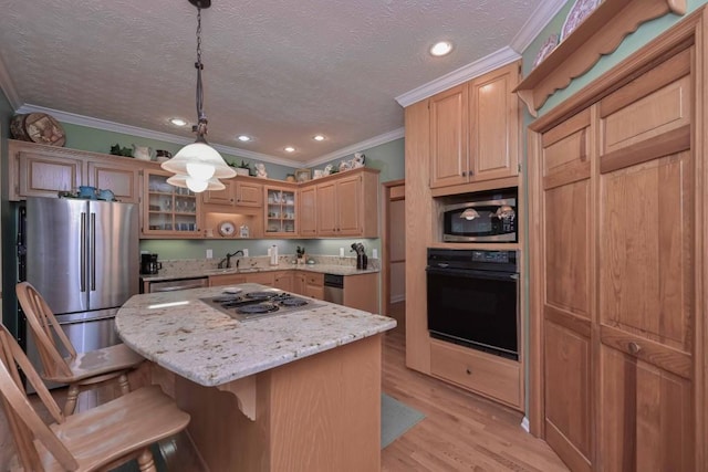 3743 Johnston Rd, Winston, GA 30187 - kitchen with stainless steel appliances, crown molding, a breakfast bar, a kitchen island, and light stone counters