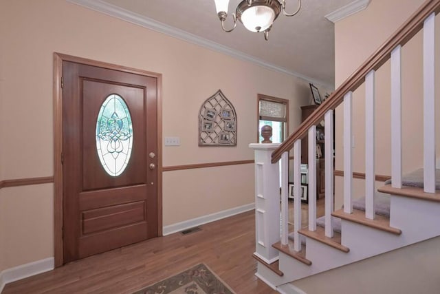 3743 Johnston Rd, Winston, GA 30187 - foyer entrance featuring stairs, crown molding, wood finished floors, and a chandelier