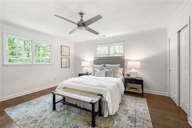 893 Vistavia Cir, Decatur, GA 30033 - bedroom with baseboards, crown molding, dark wood-style flooring, a ceiling fan, and a closet