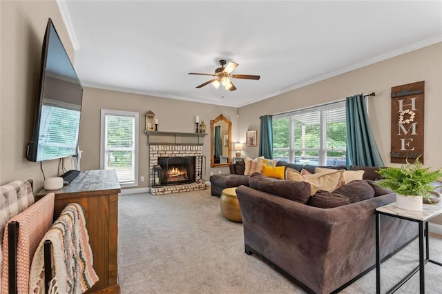 living room with a fireplace, carpet, ceiling fan, and crown molding