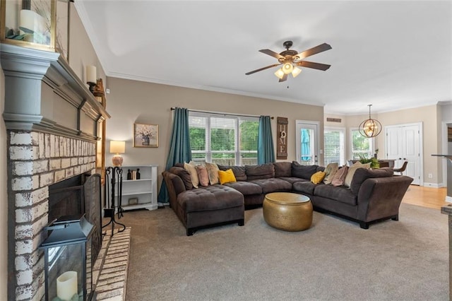 carpeted living room with ceiling fan with notable chandelier, a fireplace, and ornamental molding