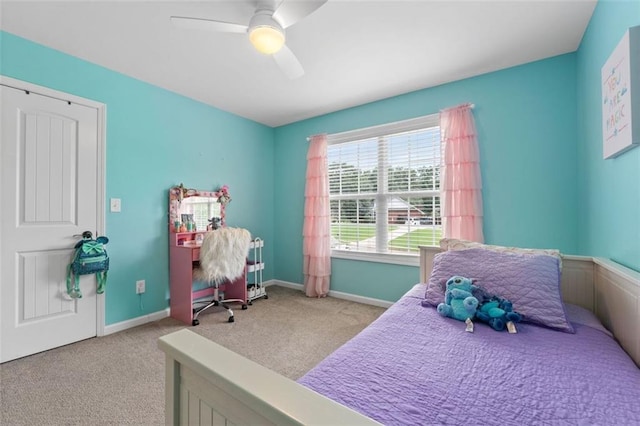 carpeted bedroom featuring baseboards and ceiling fan