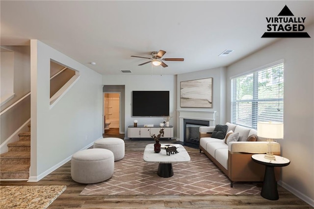 1003 Eldon Ln, Fairburn, GA 30213 - living area with wood finished floors, a ceiling fan, visible vents, baseboards, and stairway