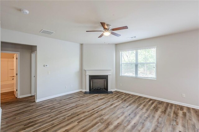 1003 Eldon Ln, Fairburn, GA 30213 - unfurnished living room with visible vents, wood finished floors, a fireplace, and ceiling fan