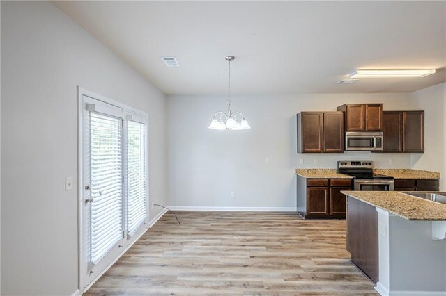 1003 Eldon Ln, Fairburn, GA 30213 - kitchen with hanging light fixtures, an inviting chandelier, light wood-type flooring, baseboards, and appliances with stainless steel finishes