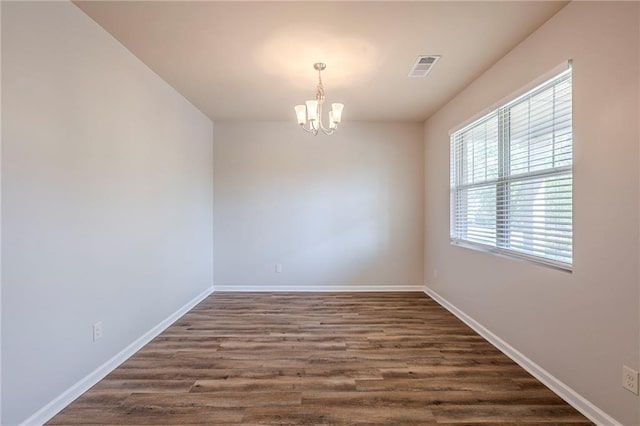 1003 Eldon Ln, Fairburn, GA 30213 - spare room featuring a wealth of natural light, visible vents, baseboards, and a notable chandelier