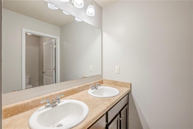 1003 Eldon Ln, Fairburn, GA 30213 - bathroom featuring double vanity, toilet, and a sink