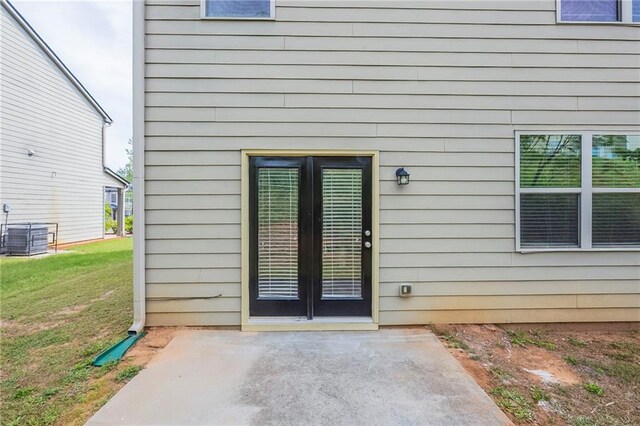 1003 Eldon Ln, Fairburn, GA 30213 - view of exterior entry with a yard, a patio, and central AC