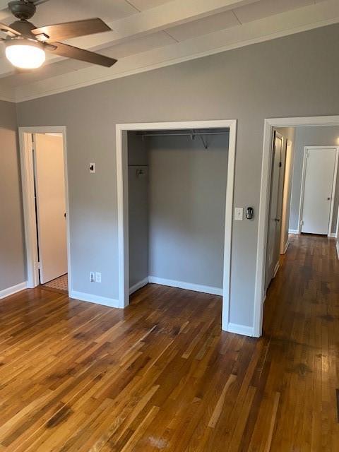 1177 Baker Ln, Marietta, GA 30062 - unfurnished bedroom featuring a closet, dark wood-type flooring, baseboards, crown molding, and ceiling fan