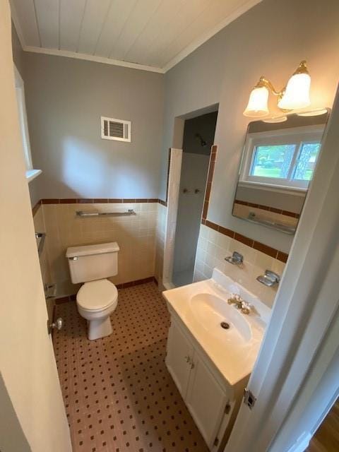 1177 Baker Ln, Marietta, GA 30062 - bathroom featuring tile walls, ornamental molding, toilet, vanity, and a wainscoted wall