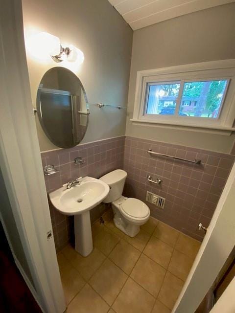1177 Baker Ln, Marietta, GA 30062 - half bathroom featuring tile walls, tile patterned flooring, toilet, and wainscoting