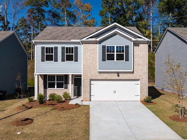 view of front of property with a garage and a front lawn