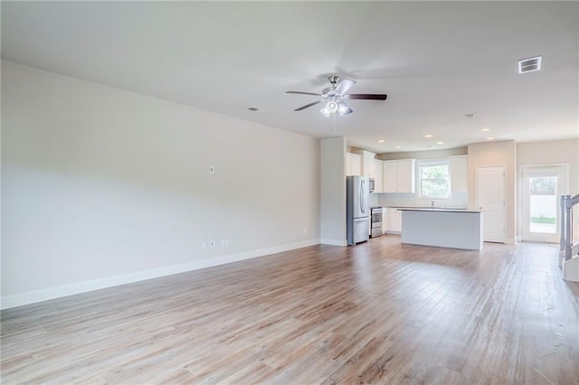 235 Orchard Dr, Covington, GA 30014 - unfurnished living room featuring light wood finished floors, ceiling fan, and recessed lighting