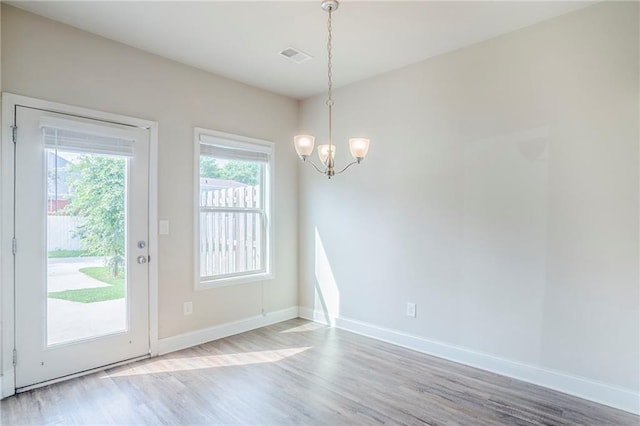 235 Orchard Dr, Covington, GA 30014 - unfurnished dining area with a chandelier and wood finished floors