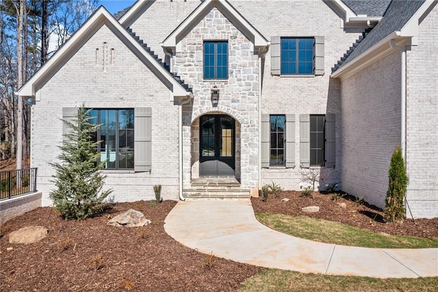 view of front of property featuring brick siding and french doors
