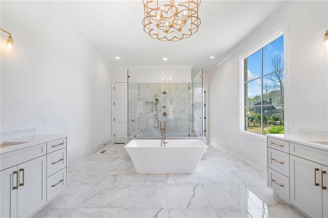 full bathroom featuring marble finish floor, ornamental molding, two vanities, and a shower stall