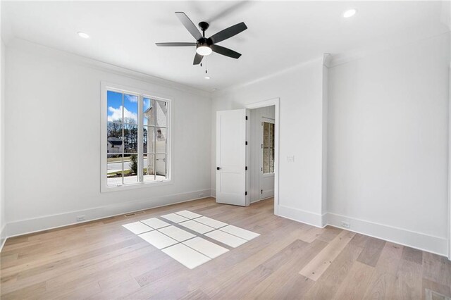 unfurnished bedroom with crown molding, baseboards, light wood finished floors, and recessed lighting