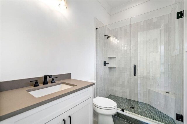 full bathroom with toilet, vanity, and a shower stall