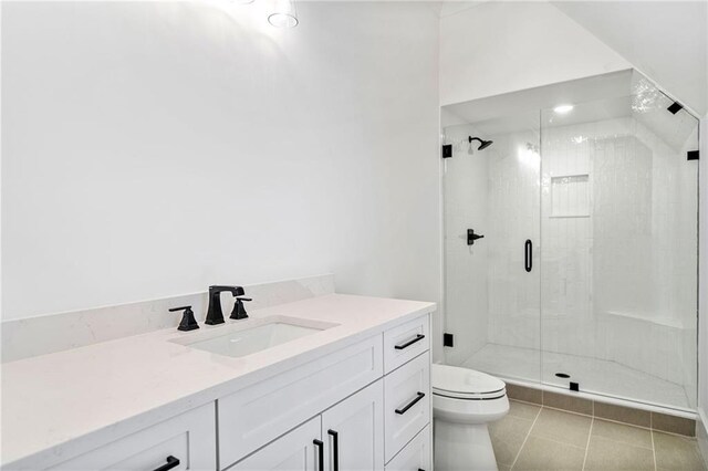 full bath featuring toilet, vanity, a stall shower, and tile patterned flooring