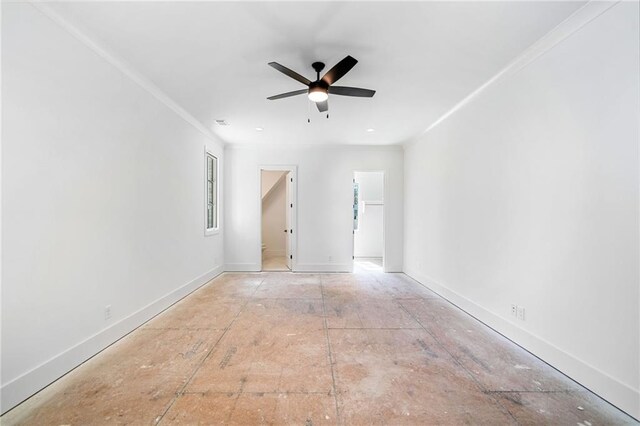 empty room featuring baseboards, crown molding, and a ceiling fan