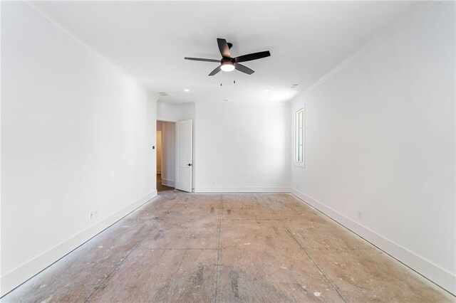 unfurnished room featuring baseboards, crown molding, and a ceiling fan